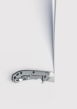 a hand knife cutting smoothly through paper